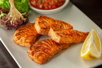 This is a hot dish of grilled red fish and tomato sauce.