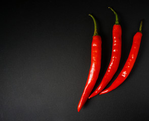Top view of red hot chili pepper over black background.