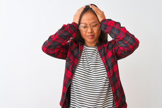 Young chinese woman wearing t-shirt jacket and glasses over isolated white background suffering from headache desperate and stressed because pain and migraine. Hands on head.