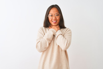 Young chinese woman wearing turtleneck sweater and glasses over isolated white background shouting and suffocate because painful strangle. Health problem. Asphyxiate and suicide concept.