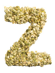 Letter Z of the English alphabet from pumpkin seeds on a white isolated background. Food pattern made from seeds. Bright alphabet for shops.