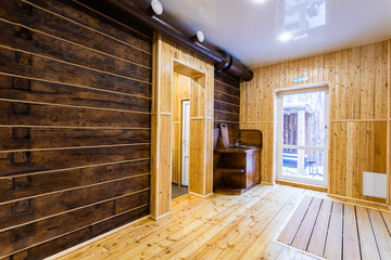 Сorridor of a country house: wall and floor, decorated with clapboard, wooden sink with board and a large window