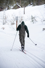 snowboarder enjoying skiing in mountains in the evening on the slope at winter ski resort