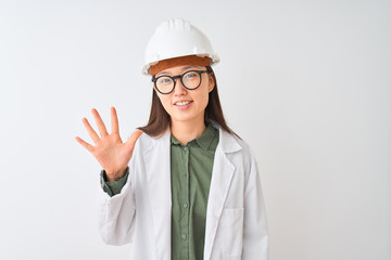 Young chinese engineer woman wearing coat helmet glasses over isolated white background showing and pointing up with fingers number five while smiling confident and happy.