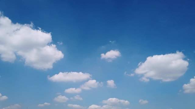 White puffy clouds and blue sky time-lapse with long second duration for background and graphics in daylight. 4K 25fps