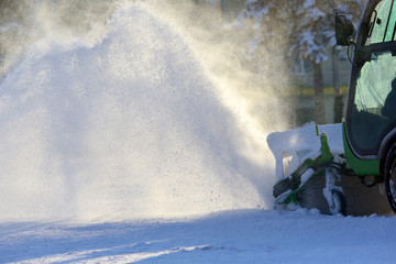 street cleaning the city from snow with the help of special machinery