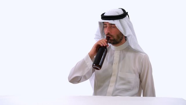 Saudi Arabian Man Drinking Nonalcoholic Beer in White Background Studio