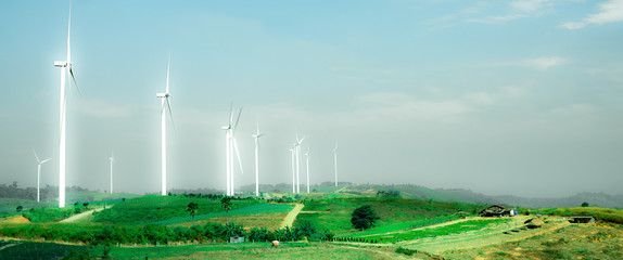 bright wind turbines in the green field
