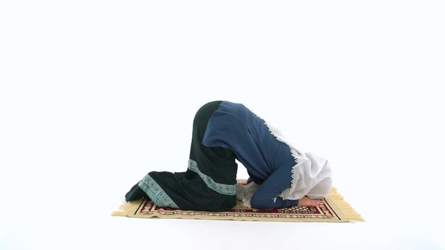 Young Muslim Woman Praying on Carpet in White Background Studio