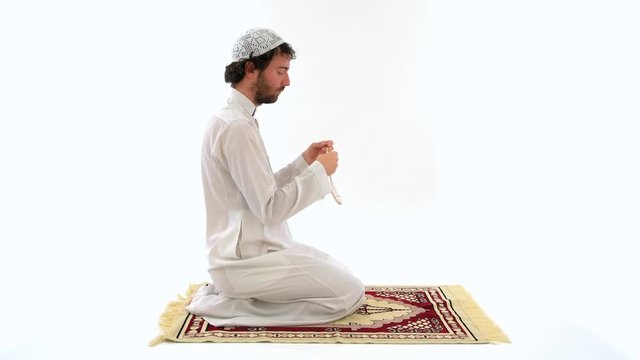 Muslim Arabian Man Praying and Conducting Salah on Carpet, Studio