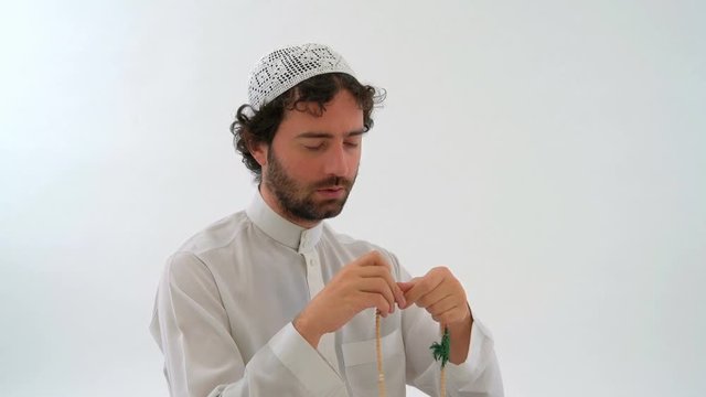 Muslim Arabian Man Praying with Tasbih in White Background Studio