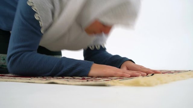 Caucasian Muslim Woman Prostrating and Praying on Carpet, Close Up