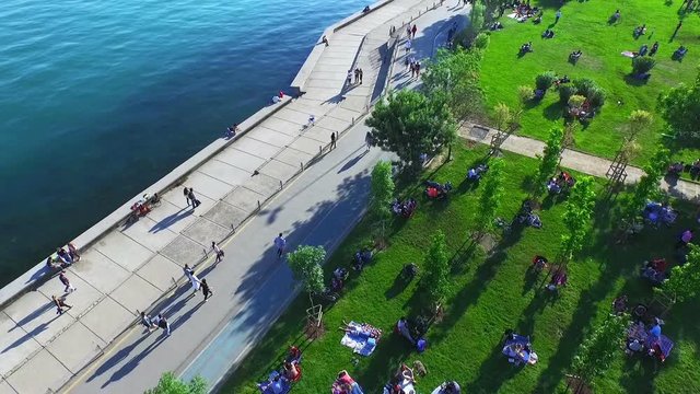 People Walking Seaside and Sitting on Grass in Kadikoy, Istanbul