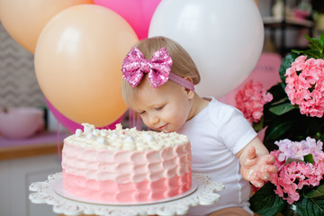 a little girl got dirty with cake and colorful balloons for her birthday. crash cake