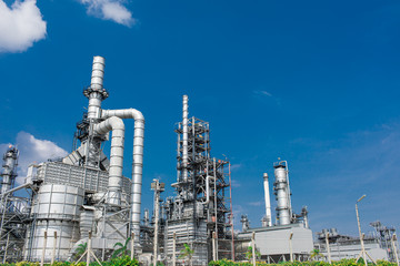 Oil and gas industrial,Oil refinery plant form industry,Refinery factory oil storage tank and pipeline steel blue sky background