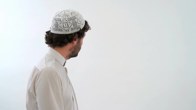 Muslim Arabian Man Performing the Taslim and Praying, White Background
