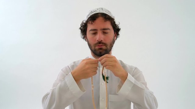 Muslim Arabian Man Praying with Tasbih in White Background Studio