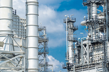 Oil and gas industrial,Oil refinery plant form industry,Refinery factory oil storage tank and pipeline steel blue sky background