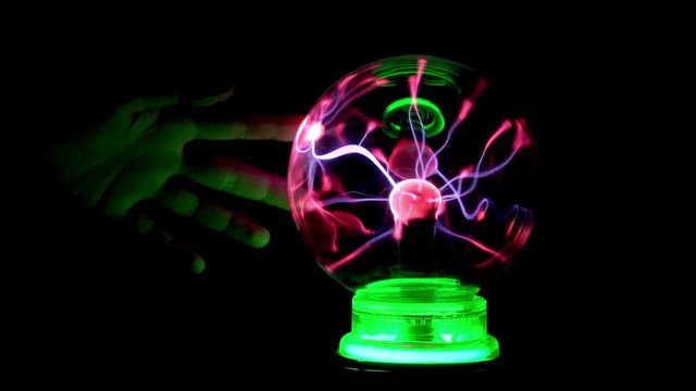 Hand Touch Tesla Coil Plasma Ball in Darkness, Black Background