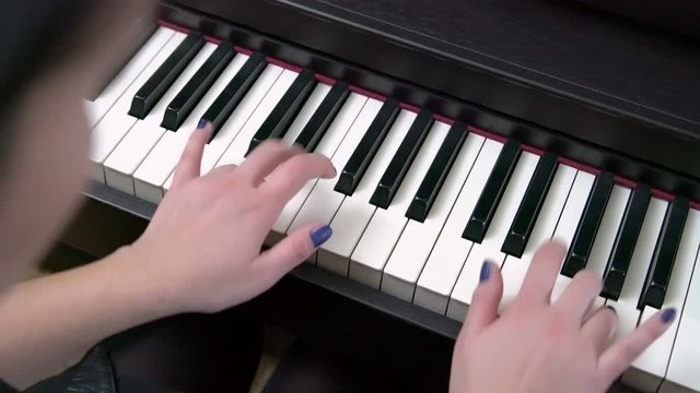Young Female Pianist Hands Playing Grand Piano Top View