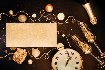 Christmas dark background. Golden Christmas items and decorations, glasses, champagne, watches. Christmas celebration concept. Flat lay top view composition