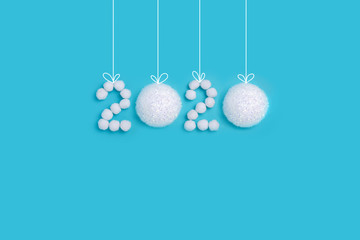 Celebrating New Year 2020. Figures from white snow balls on a blue background. Creative concept of minimalism, flat lay