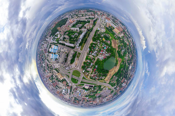 Aerial view of the city with traffic, streets and buildings with green trees and rails under the blue sky with clouds at summer day in Novosibirsk, Frunze. Panoramic 360 degrees of the planet.