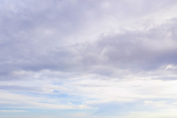 Blue sky with soft white and gray clouds. Natural background and texture.