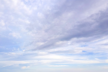 Blue sky with soft white and gray clouds. Natural background and texture.