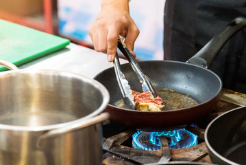 Chef preparing food in the kitchen, chef cooking, closeup
