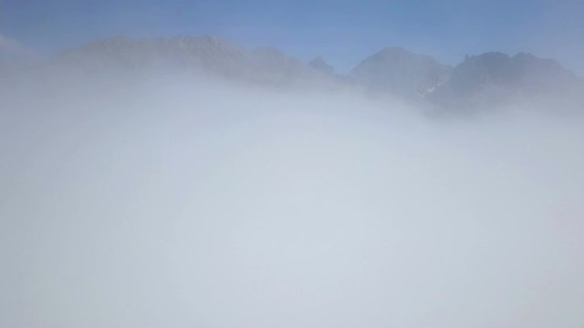 Drone flying cloud view, Peak top foggy mountains, blue sky