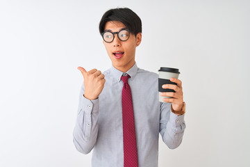 Chinese businessman wearing tie and glasses drinking coffee over isolated white background pointing and showing with thumb up to the side with happy face smiling
