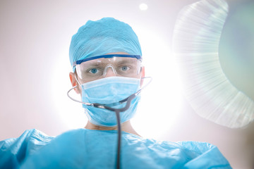 Doctor male surgeon in uniform working with a stethoscope in a medical office.