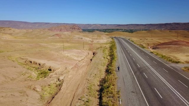 A man walking alone on the higway in Igdir, Turkey