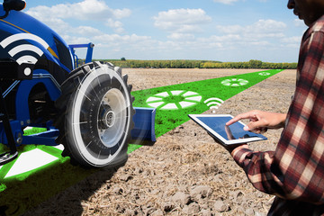 IOT smart industry robot 4.0 agriculture concept.Autonomous tractor working in farm.Smart farming...