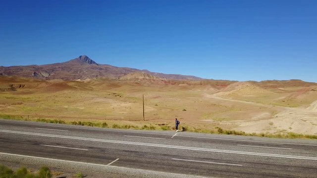 A man walking alone on the higway in Igdir, Turkey