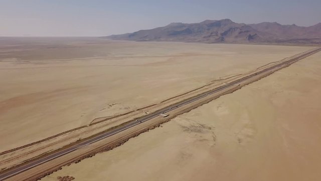 Dusty highway on the oriental yellow desert in Iran