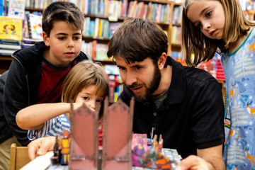 Family looking at 3D book in bookstore