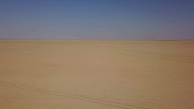 Yellow desert sand and dust in the blue sky, Iran
