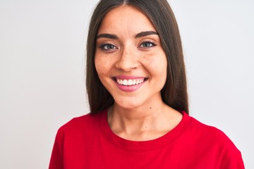 Young beautiful woman wearing red casual t-shirt standing over isolated white background with a...