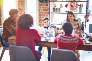 Beautiful family smiling happy and confident. Eating roasted turkey celebrating christmas at home