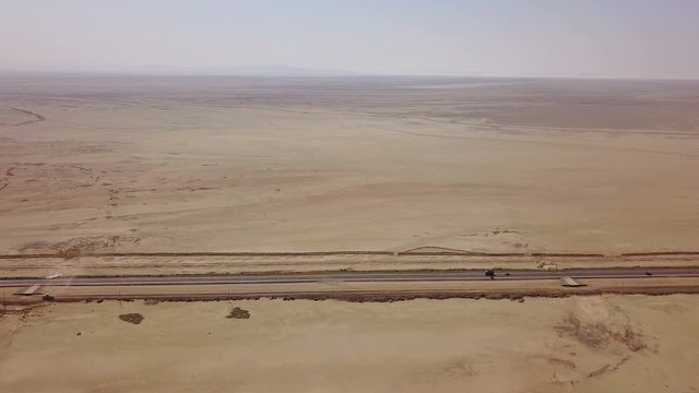 Dusty highway on the oriental yellow desert in Iran