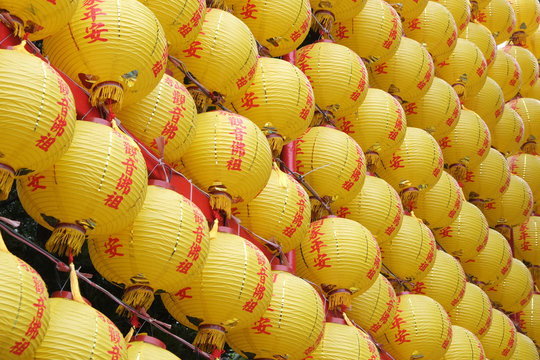 Round yellow paper Chinese lantern with red Chinese alphabet in pattern