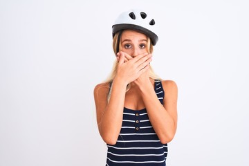 Young beautiful woman wearing bike helmet standing over isolated white background shocked covering mouth with hands for mistake. Secret concept.