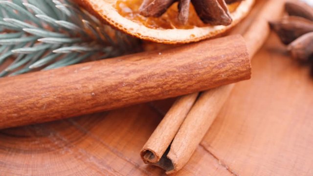 Christmas background: dried oranges, anise stars, cinnamon sticks, sprig of spruce.Close-up.