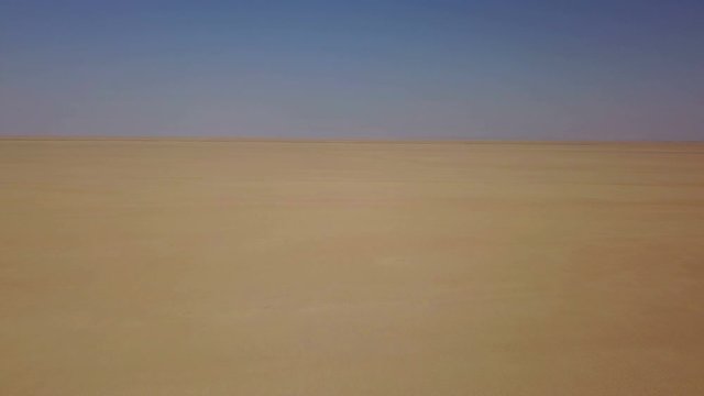 Yellow desert sand and dust in the blue sky, Iran