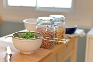 Boil asparagus, baby corn, peanuts and cashews  in the kitchen