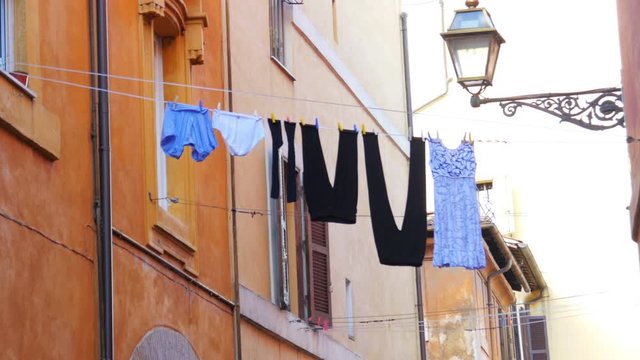 traditional laundry, clothes linen on street, between apartments, rome, italy