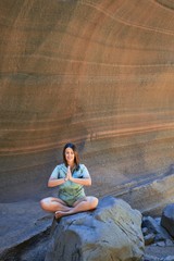 Young beauitufl hiker woman trekking natural orange mountain doing yoga pose on summer holidays