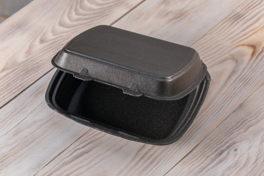 Black Foam And Plastic Food Container On Wood Table Background